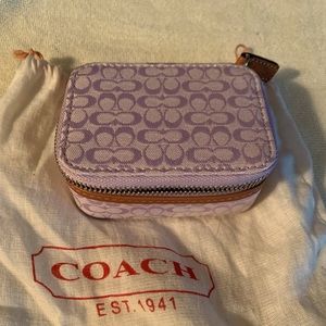 Coach pill case with 3 bottles. Tan material with light brown leather trim